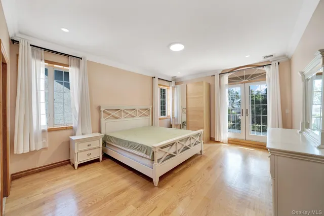 a spacious bedroom with a bed and a large window