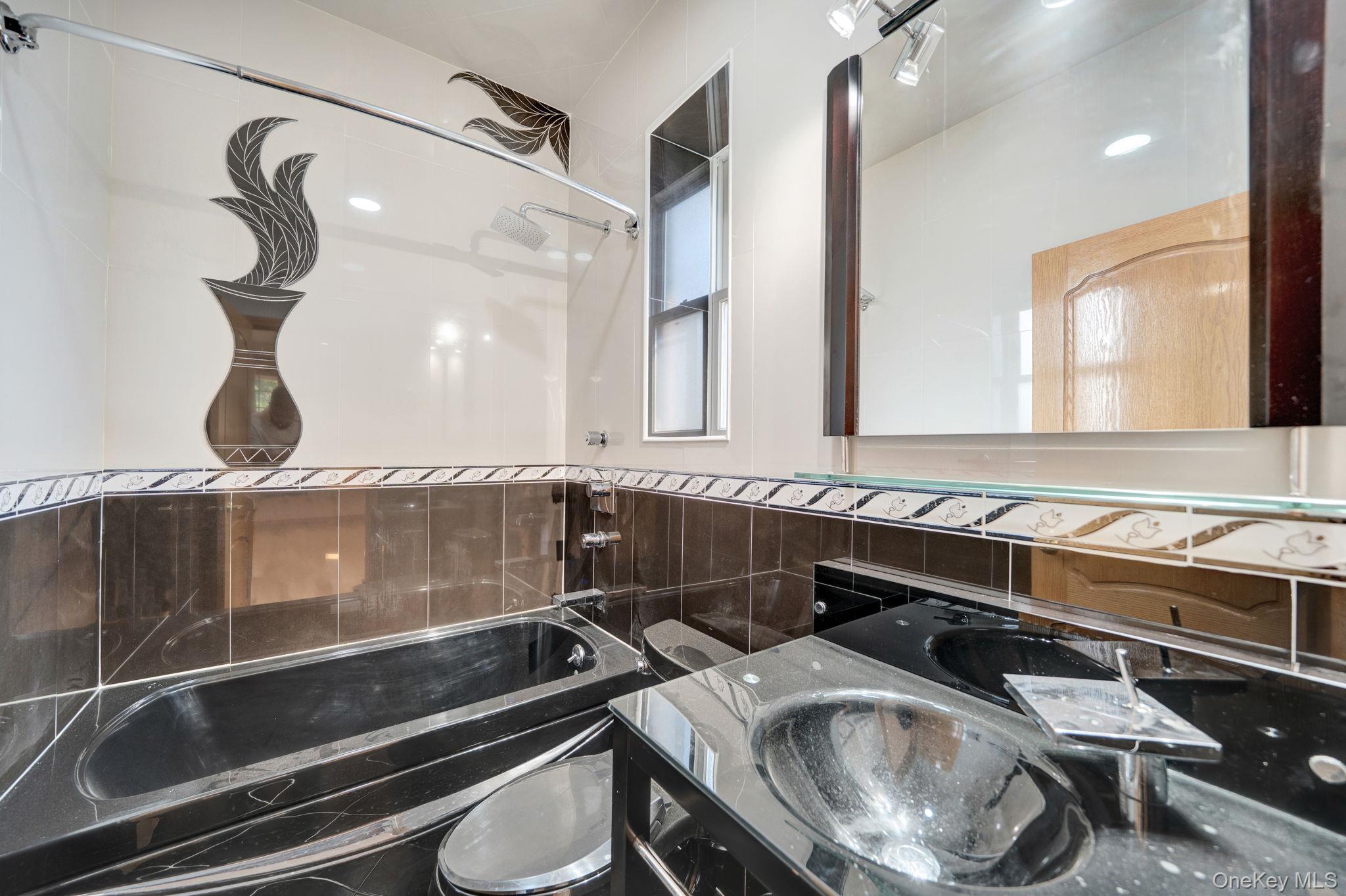 84-29 Kendrick Place Queens, NY 11432 - Photo 35 of 50 a bathroom with a sink and a mirror