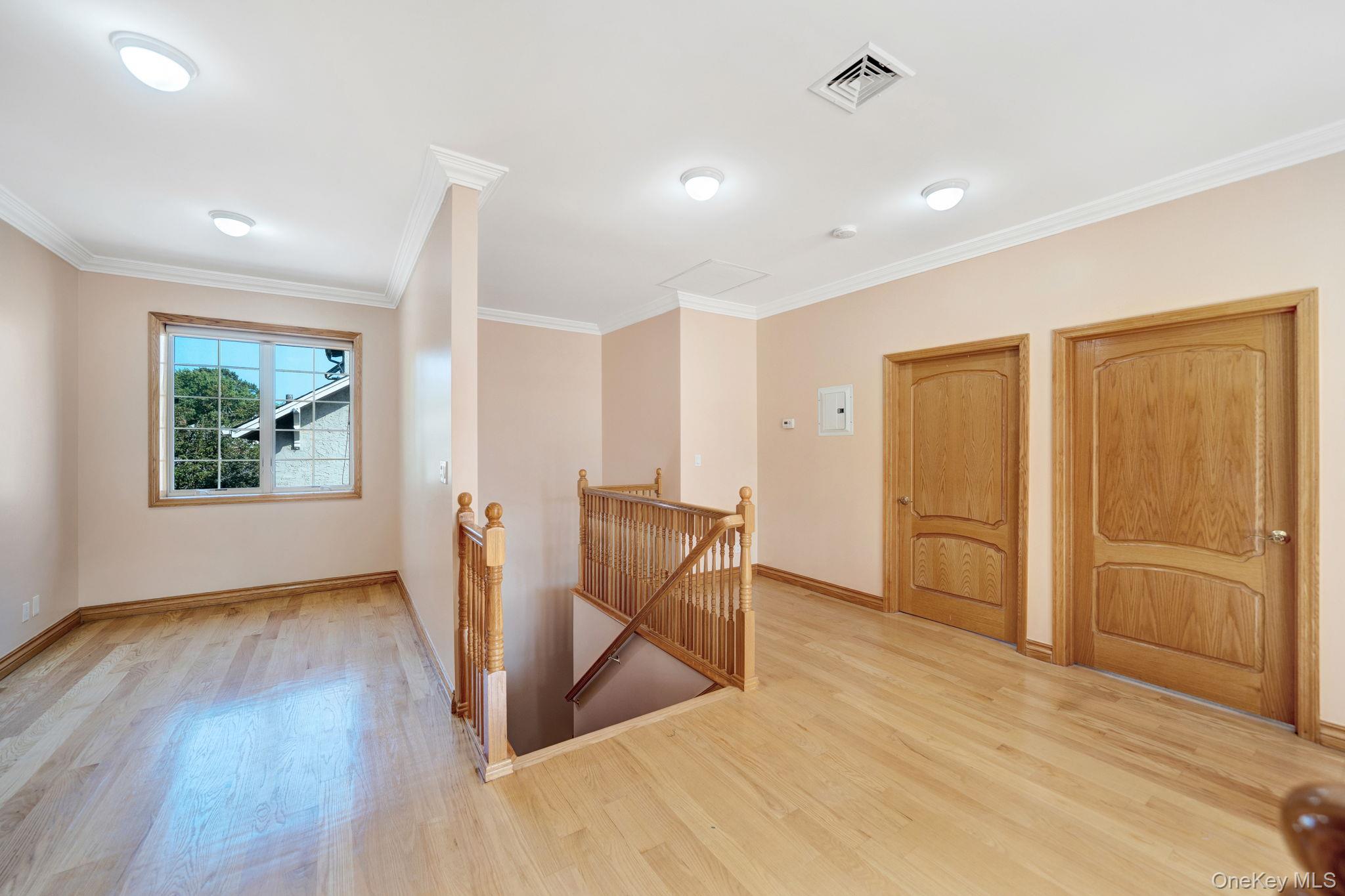 84-29 Kendrick Place Queens, NY 11432 - Photo 37 of 50 an empty room with wooden floor and windows