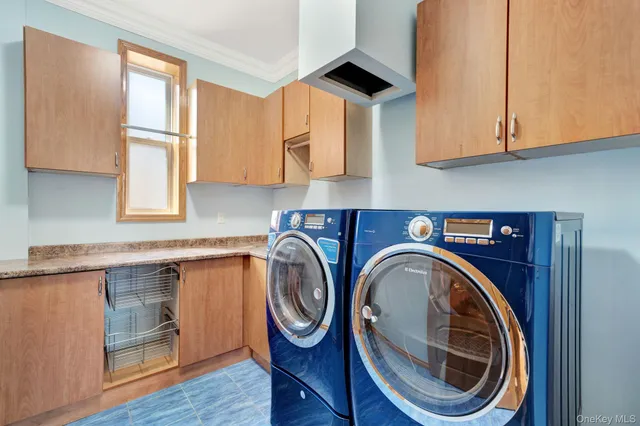 a utility room with sink dryer and washer