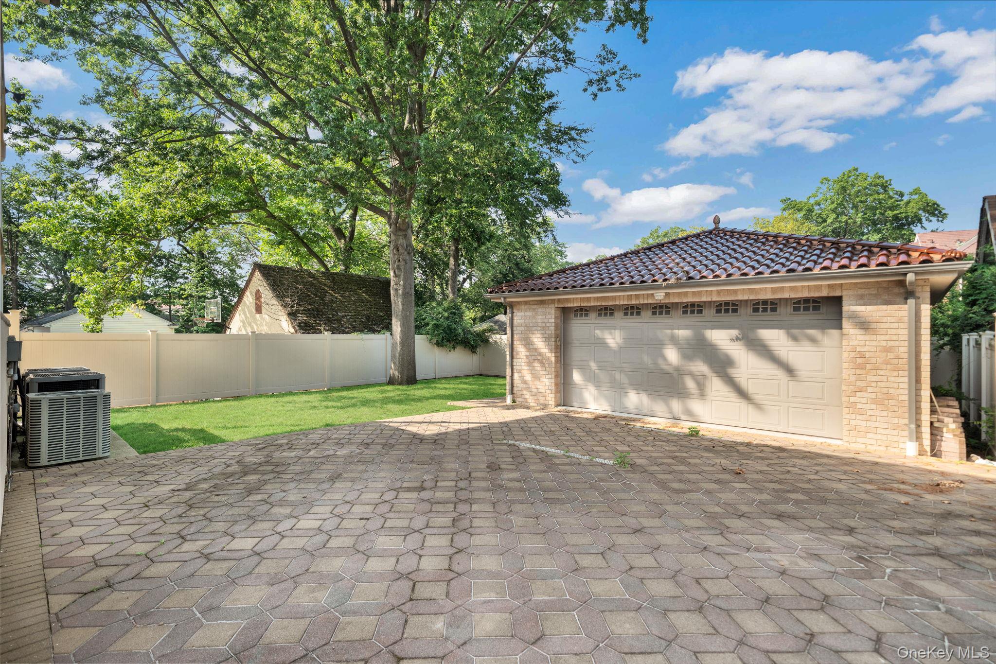 84-29 Kendrick Place Queens, NY 11432 - Photo 45 of 50 a front view of a house with a yard and garage