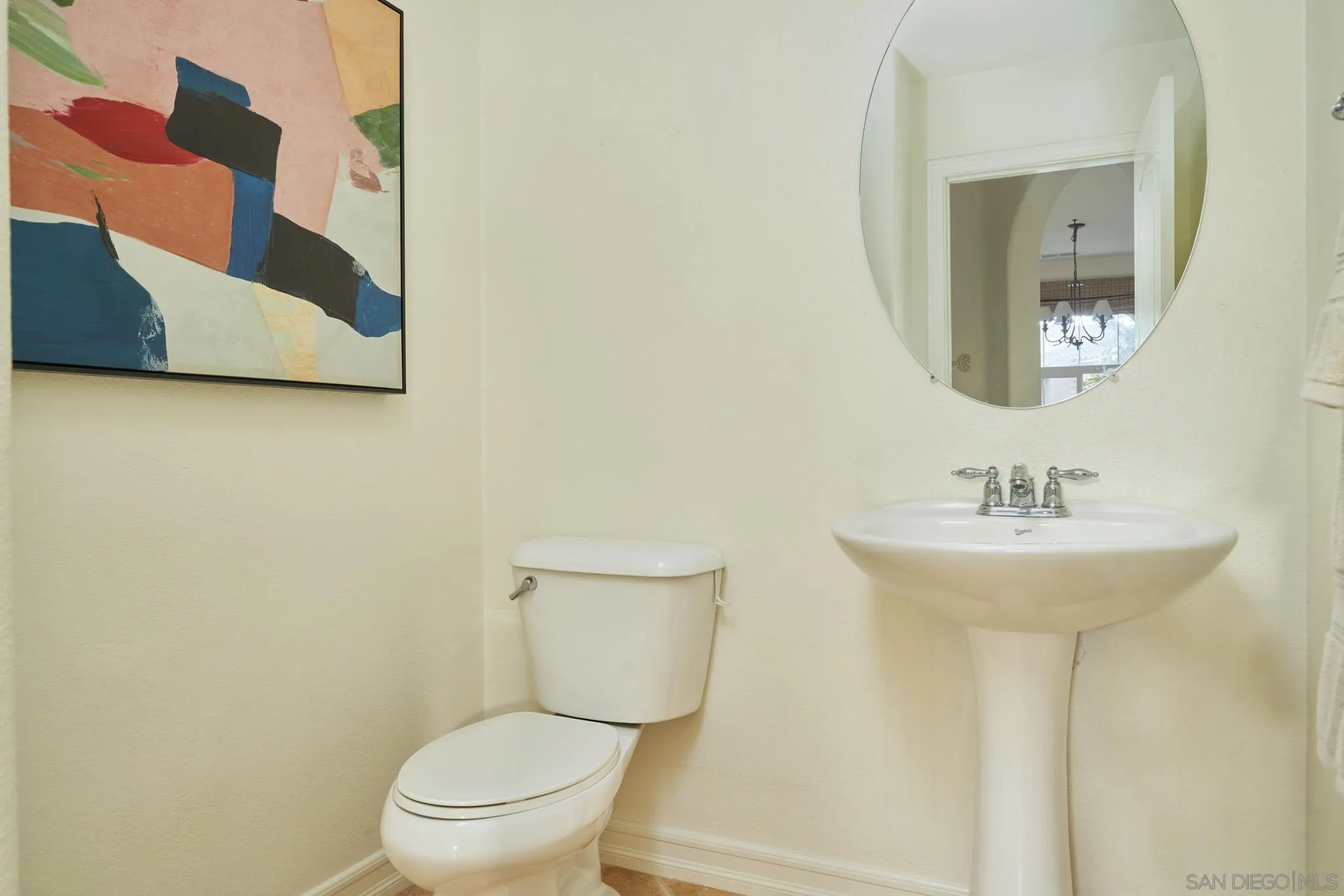 3177 Via Iris Carlsbad, CA 92009 - Photo 13 of 31 a bathroom with a toilet sink and mirror