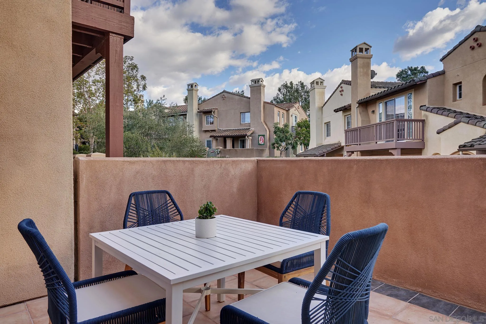 3177 Via Iris Carlsbad, CA 92009 - Photo 3 of 31 a roof of a house with table and chairs