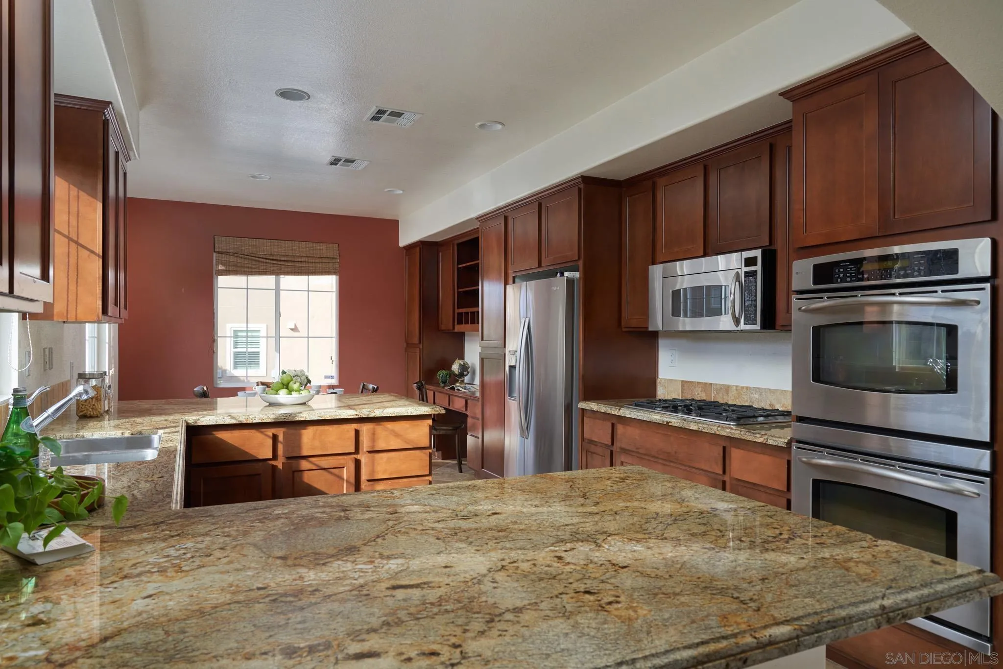 3177 Via Iris Carlsbad, CA 92009 - Photo 10 of 31 a kitchen with stainless steel appliances a stove a refrigerator and a sink