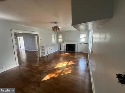 an empty room with wooden floor and closet
