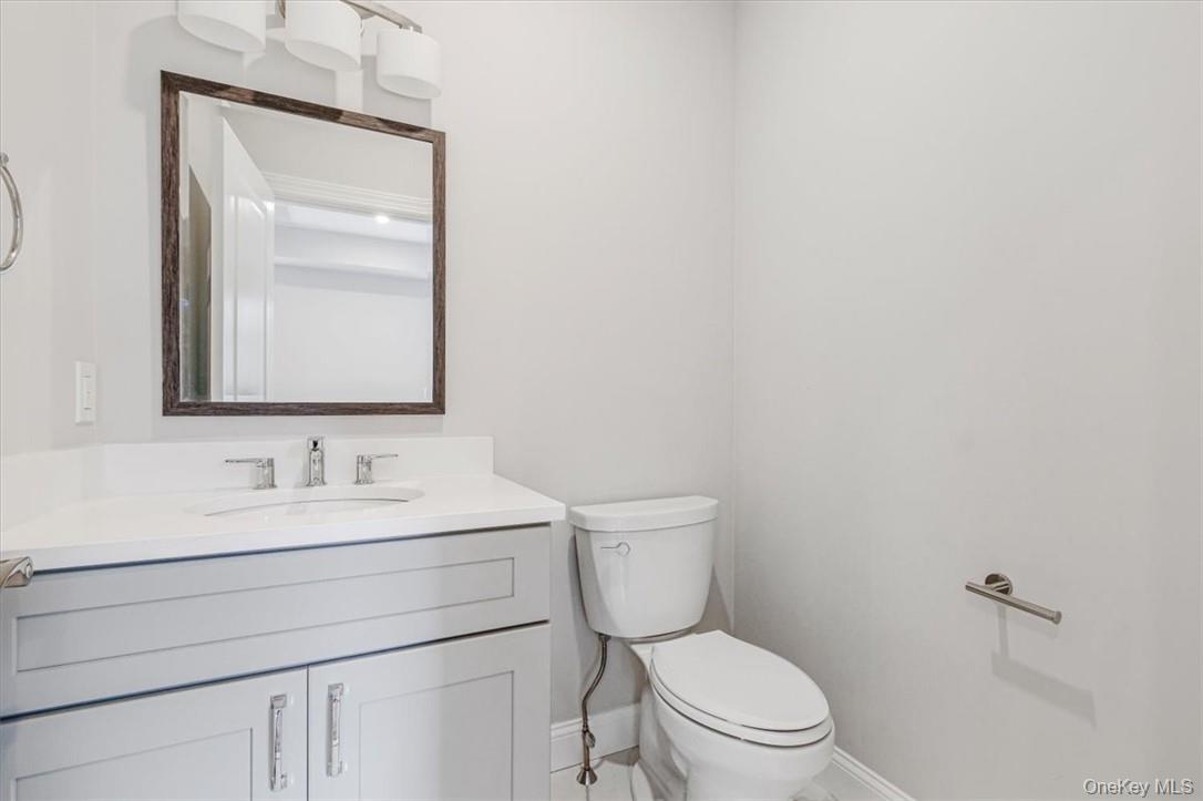 125 Vail Avenue, Unit F Peekskill, NY 10566 - Photo 11 of 26 a bathroom with a toilet sink vanity and mirror