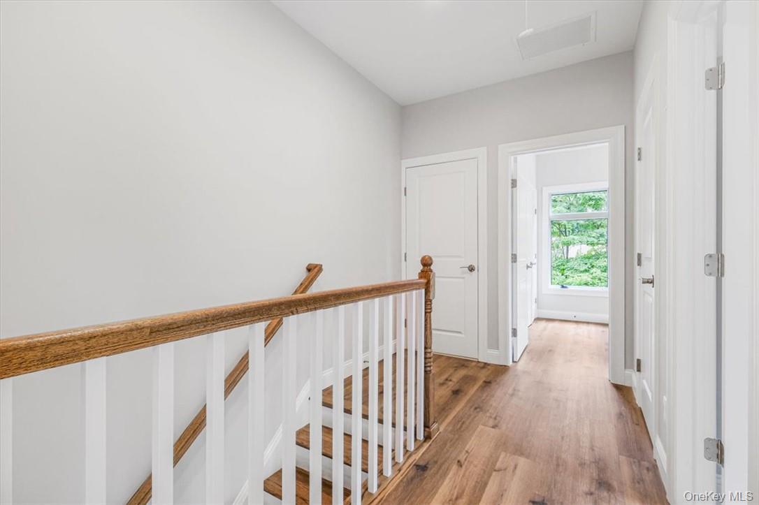 125 Vail Avenue, Unit F Peekskill, NY 10566 - Photo 12 of 26 a view of a hallway with wooden floor and staircase