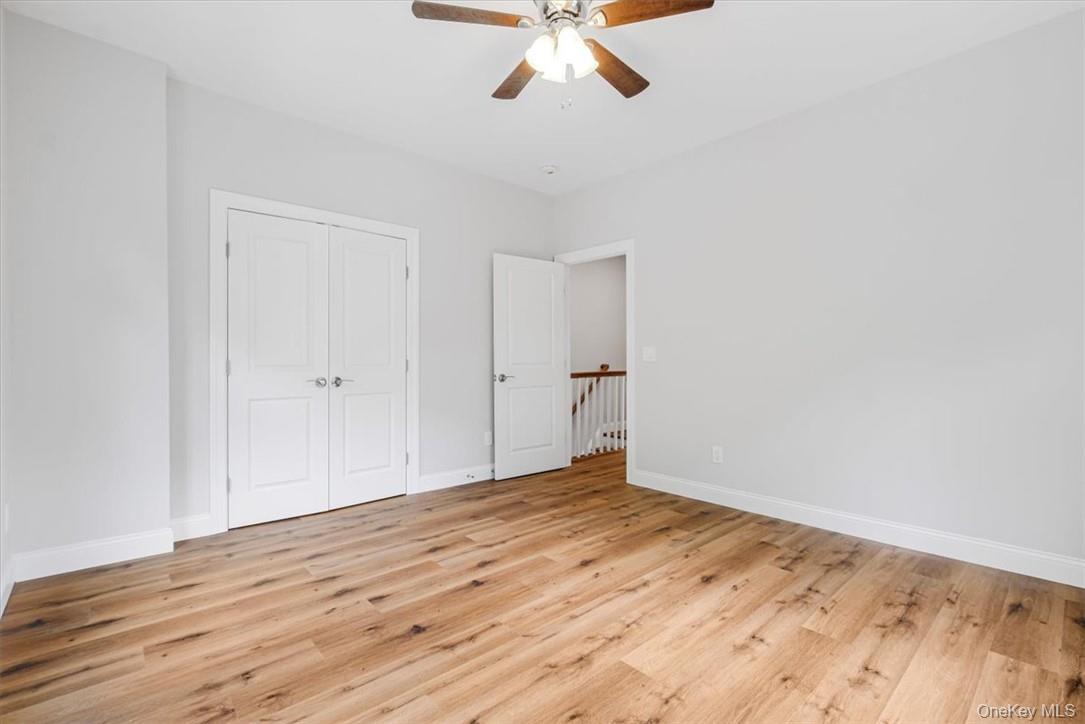 125 Vail Avenue, Unit F Peekskill, NY 10566 - Photo 16 of 26 a view of empty room with wooden floor and ceiling fan