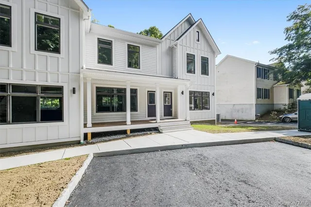 a view of an house with swimming pool and porch