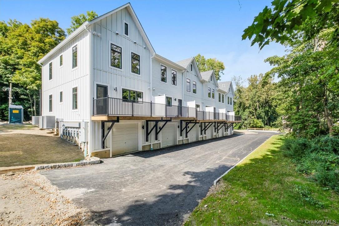 125 Vail Avenue, Unit F Peekskill, NY 10566 - Photo 21 of 26 a front view of a house with a yard garage and outdoor seating