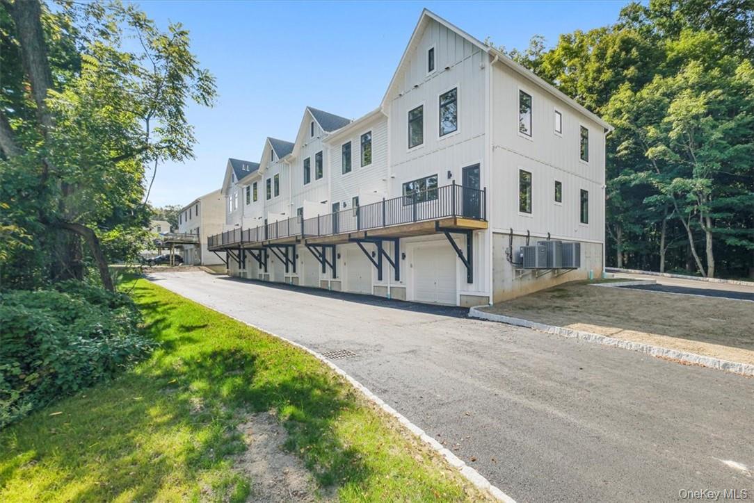 125 Vail Avenue, Unit F Peekskill, NY 10566 - Photo 22 of 26 a view of a white house with a yard