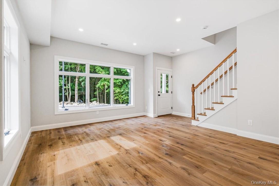 125 Vail Avenue, Unit F Peekskill, NY 10566 - Photo 3 of 26 a view of an empty room with wooden floor and a window