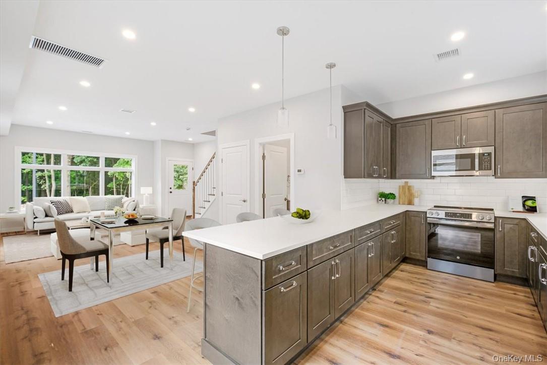 125 Vail Avenue, Unit F Peekskill, NY 10566 - Photo 4 of 26 a large kitchen with stainless steel appliances lots of counter space sink and a window