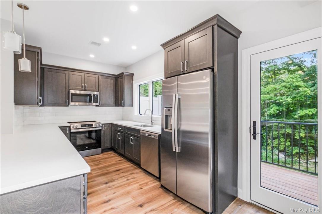 125 Vail Avenue, Unit F Peekskill, NY 10566 - Photo 8 of 26 a kitchen with stainless steel appliances granite countertop a refrigerator a stove a sink and dishwasher