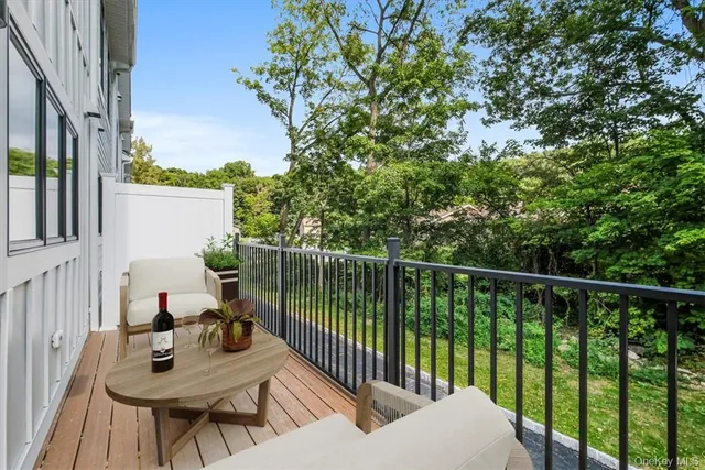 a view of a balcony with two chairs and a table