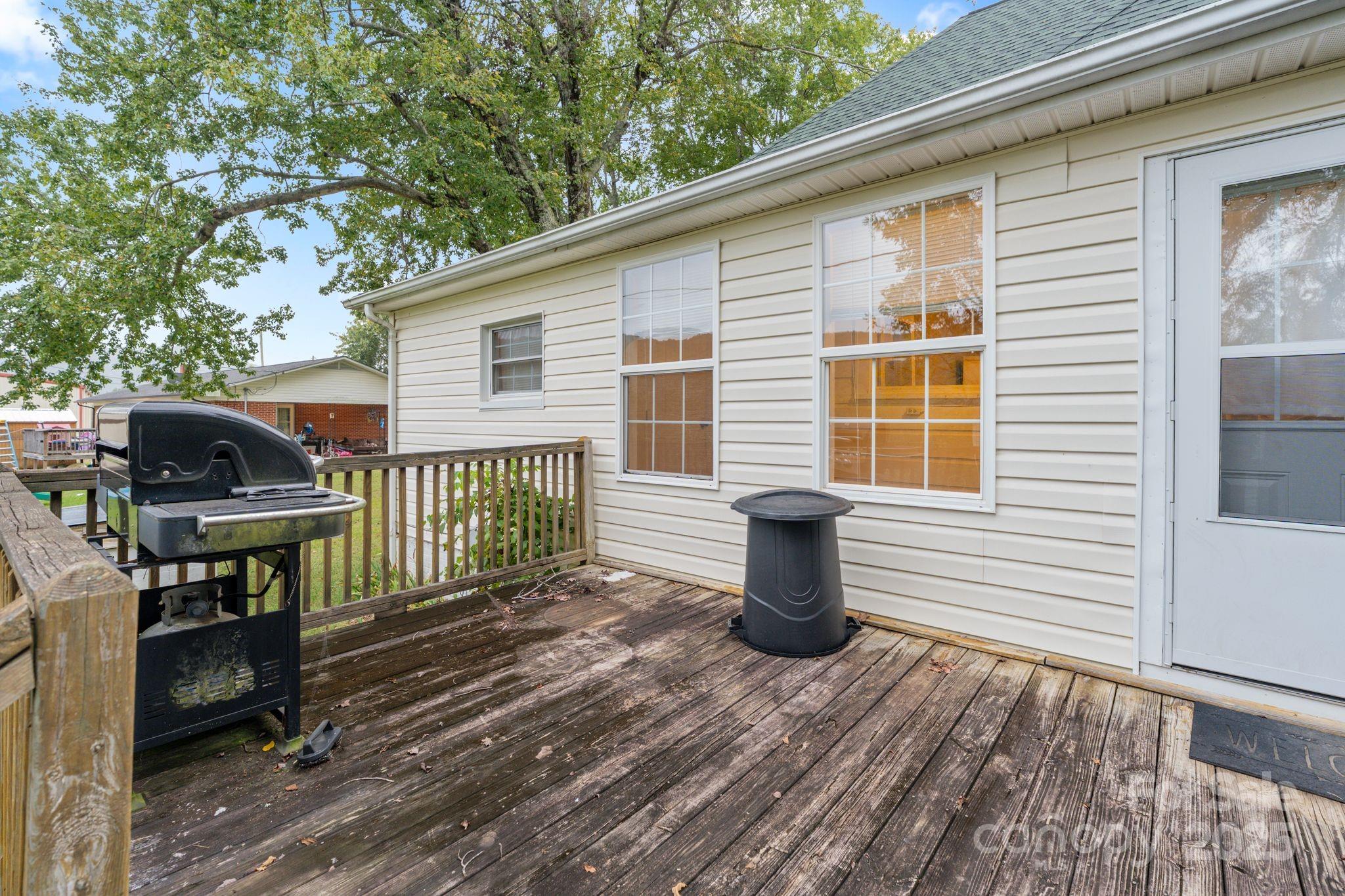 6921 Harmony Grove Road Nebo, NC 28761 - Photo 14 of 20 a view of a patio with table and chairs and wooden floor