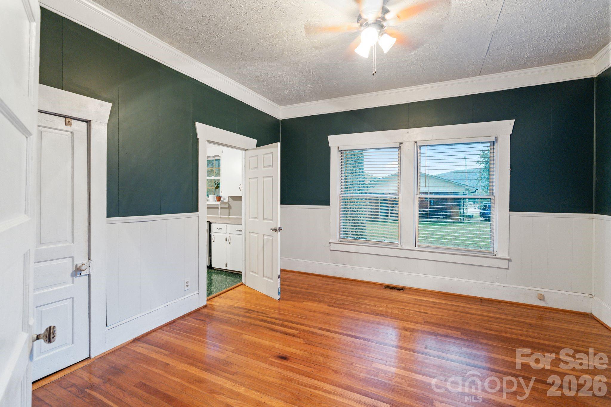 6921 Harmony Grove Road Nebo, NC 28761 - Photo 16 of 21 a view of empty room with wooden floor and fan