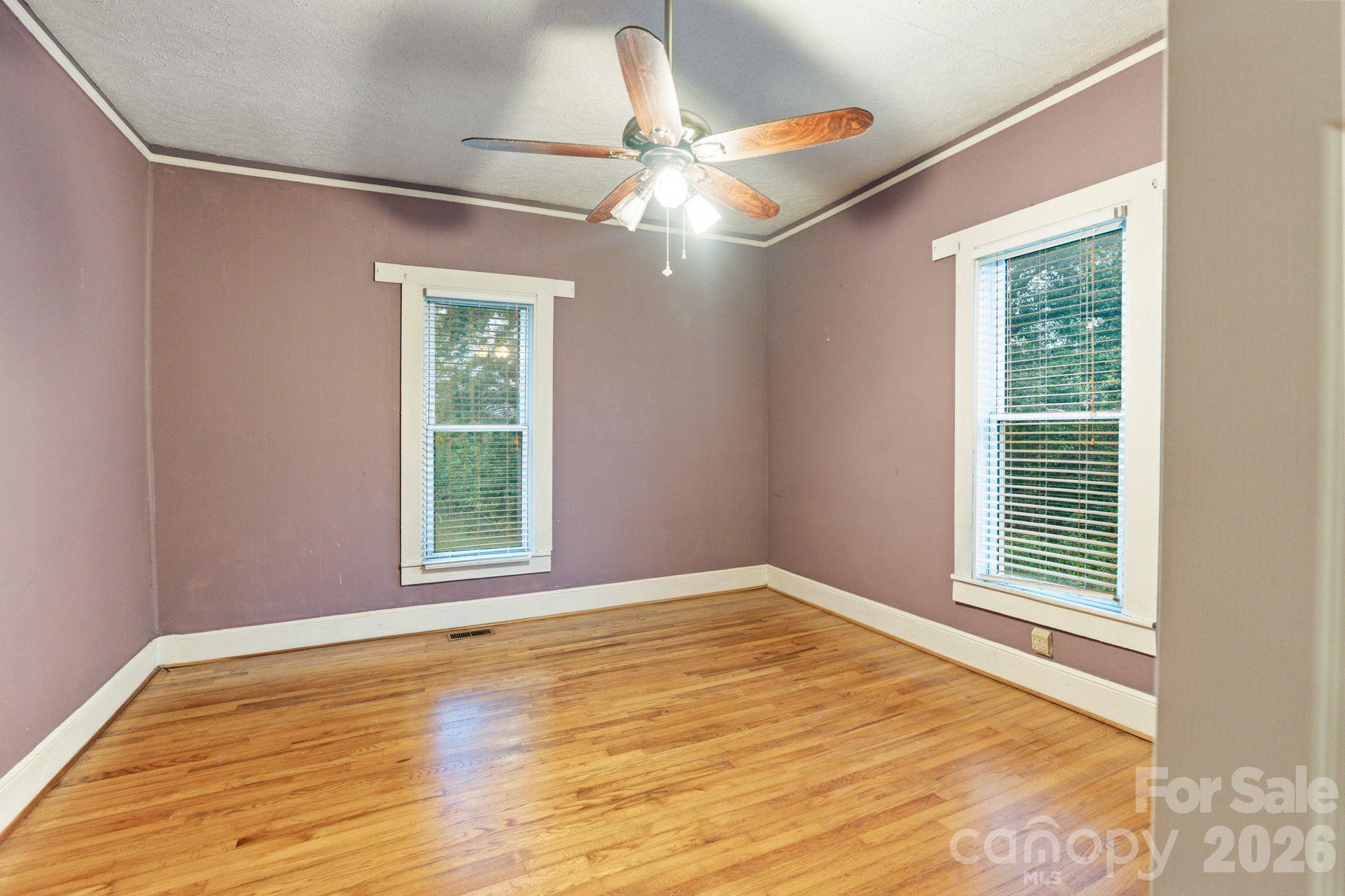 6921 Harmony Grove Road Nebo, NC 28761 - Photo 18 of 21 a view of an empty room with wooden floor and a window
