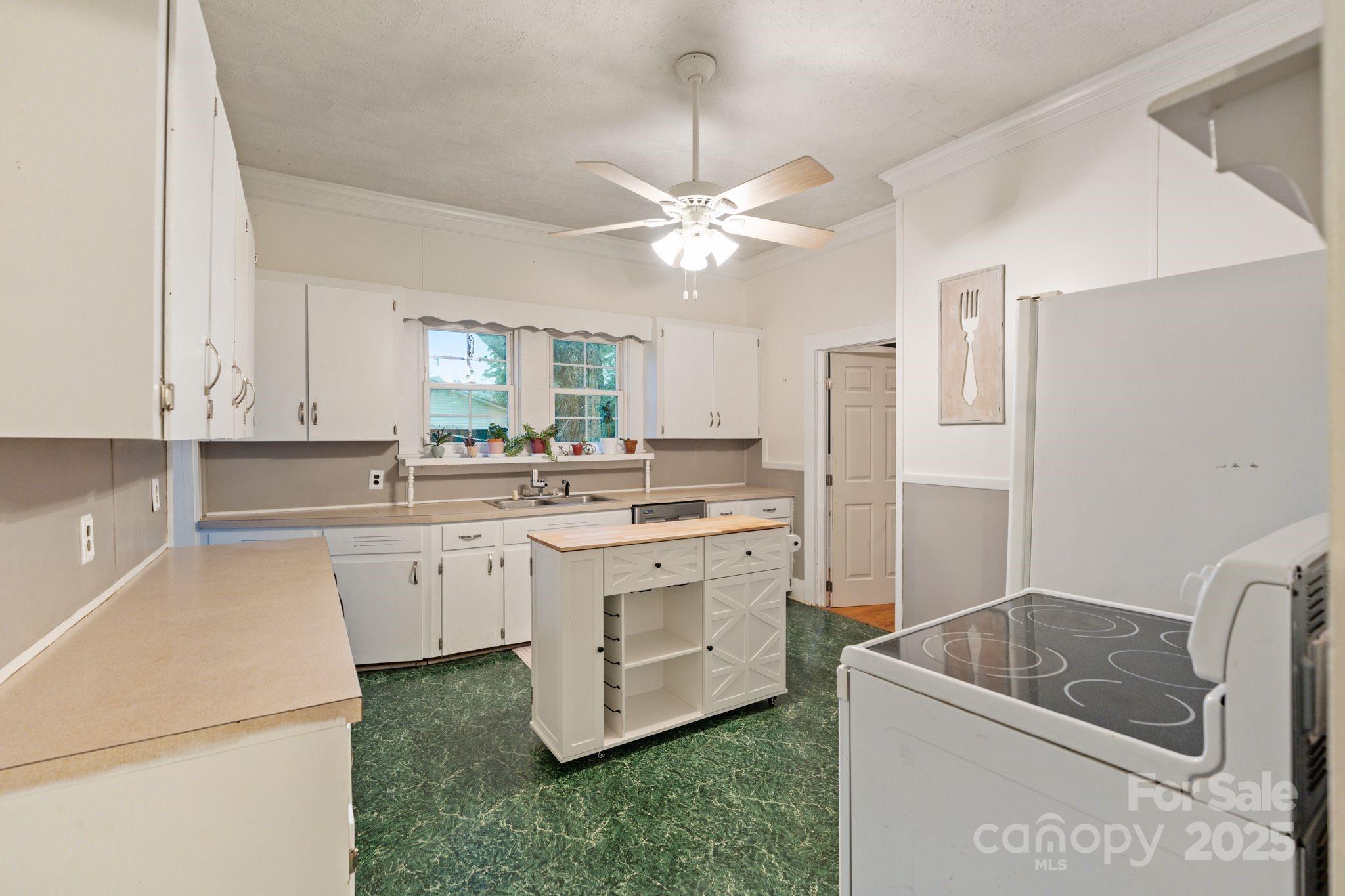 6921 Harmony Grove Road Nebo, NC 28761 - Photo 10 of 20 a kitchen with a sink cabinets and window