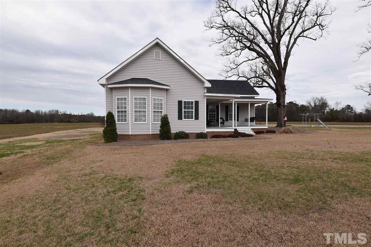 2001 Harvey Lewis Road Faison, NC 28341 - Photo 1 of 25 a front view of a house with a yard and lake view