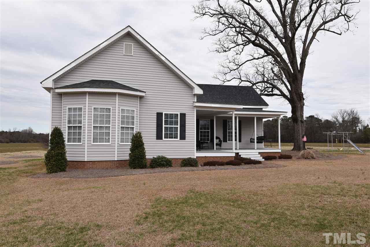 2001 Harvey Lewis Road Faison, NC 28341 - Photo 2 of 25 a front view of a house with a yard and seating space