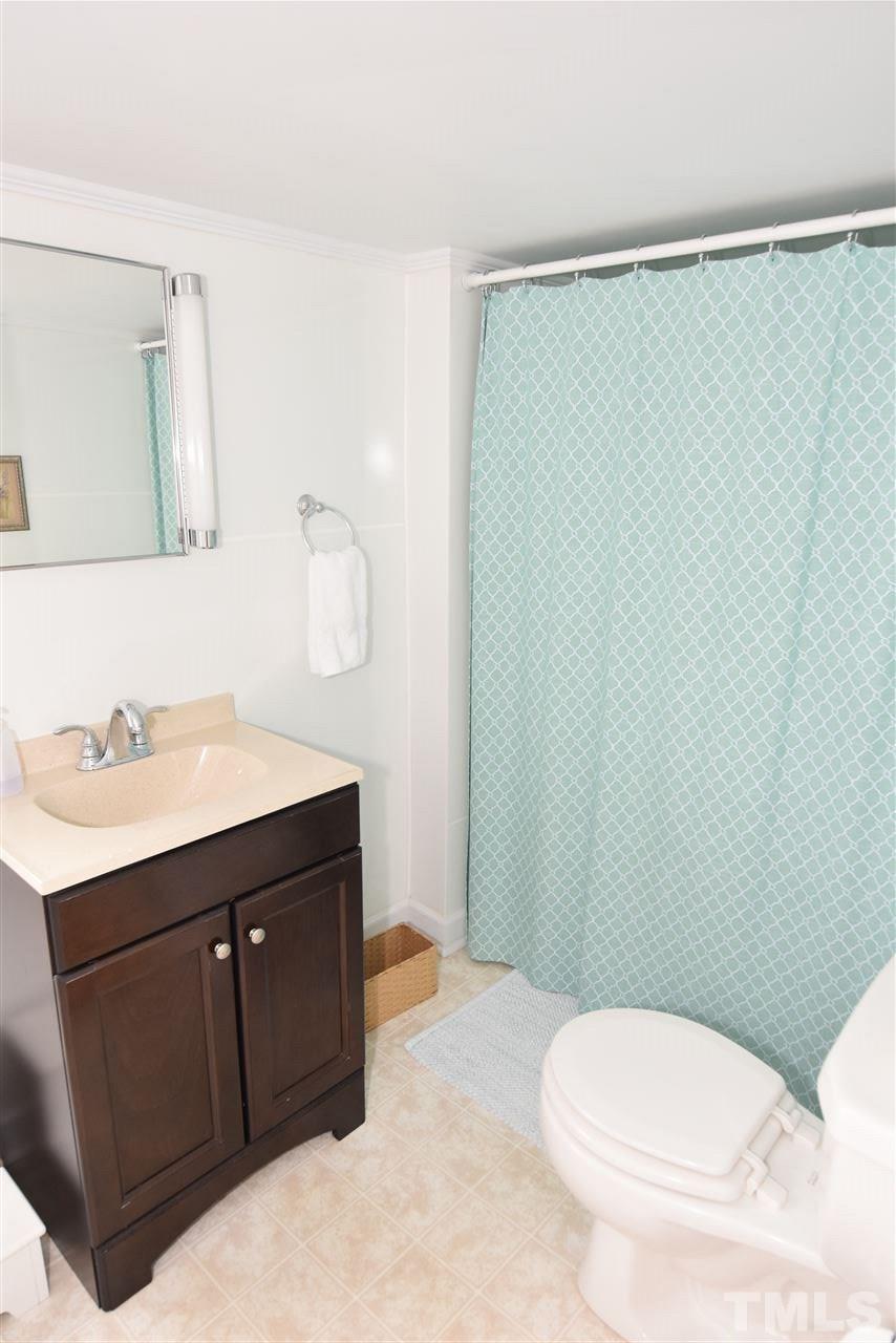 2001 Harvey Lewis Road Faison, NC 28341 - Photo 20 of 25 a bathroom with a sink a toilet and vanity