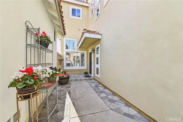 a view of an empty room with a window and kitchen view