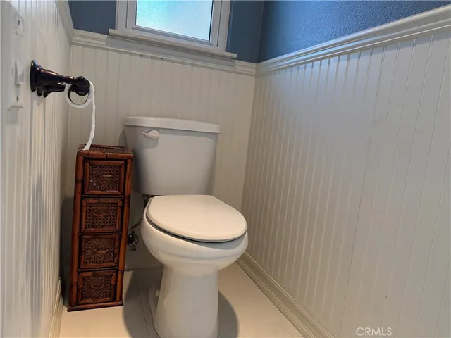 a view of an empty room with window and closet area