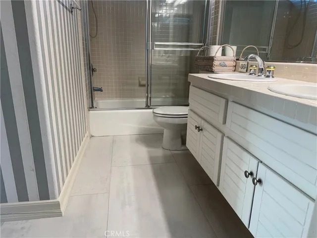 an empty room with fan and windows