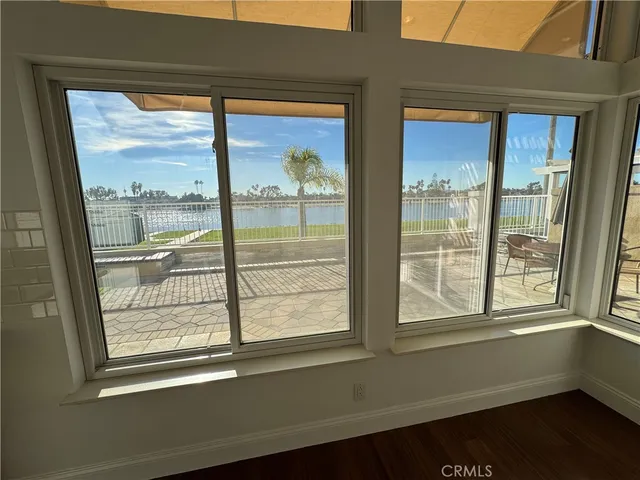 a view of a livingroom with wooden floor and a fireplace