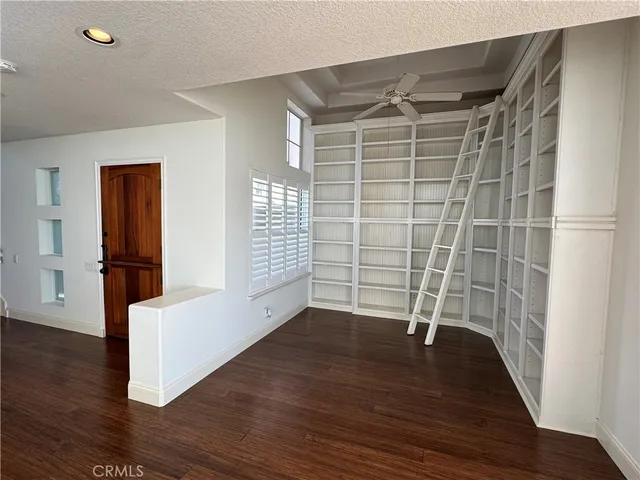 a front view of a house with a yard and potted plants