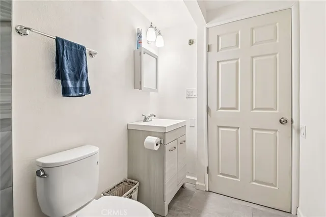 a front view of a house with a garden and trees