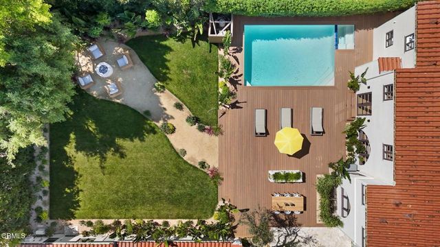 an aerial view of residential houses with outdoor space and street view