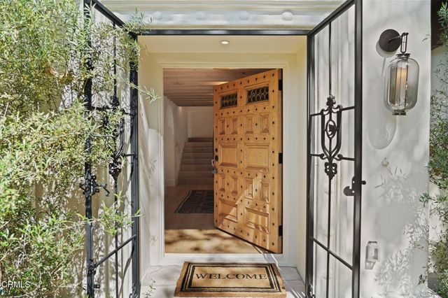 a living room with fireplace furniture and a chandelier