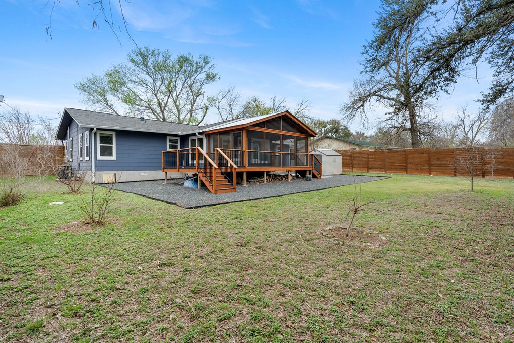 3404 Touchstone Street Austin, TX 78723 - Photo 26 of 33 Back of house featuring a sunroom, a shed, a wooden deck, and a fenced backyard