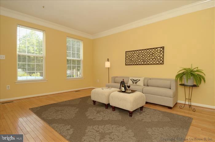 52 Golden Ash Way Gaithersburg, MD 20878 - Photo 2 of 31 a spacious bedroom with a bed and a couch