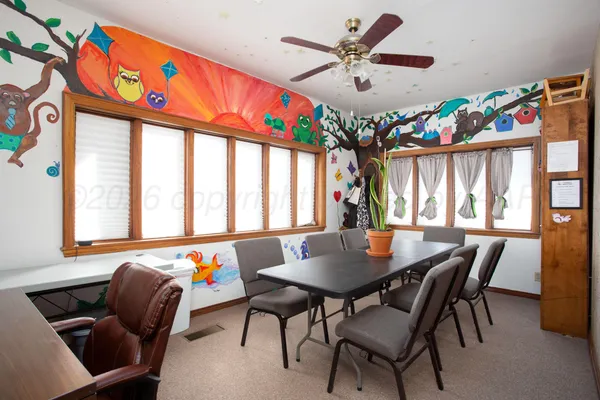 a dining room with furniture and window