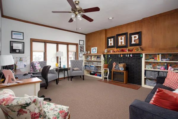 a living room with furniture and a fireplace