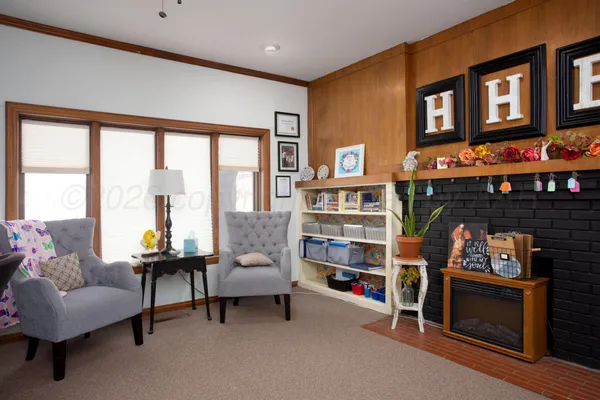 a living room with furniture and a fireplace