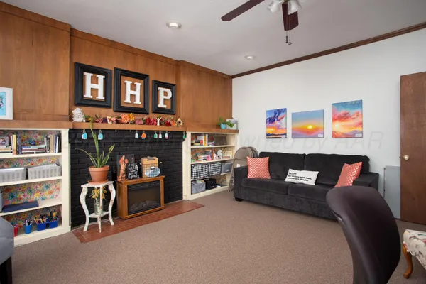 a living room with furniture and a fireplace