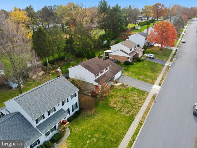 an aerial view of a house with a swimming pool yard and outdoor seating