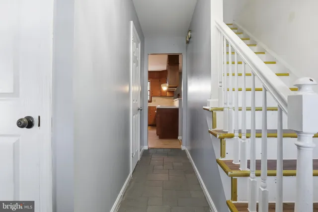 a view of staircase with lots of frames on wall and stairs