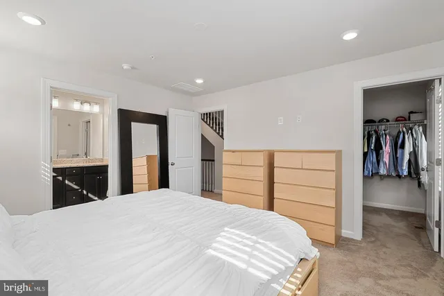 a bedroom with a large bed and a walk in closet