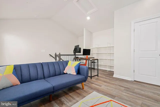 a living room with furniture and kitchen view