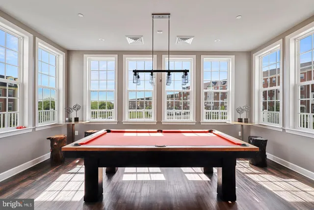 a room with pool table and windows