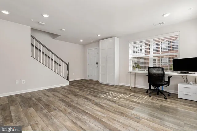 a view of a livingroom with workspace and a window