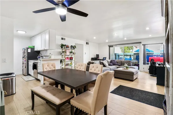 a living room with furniture kitchen view and a table