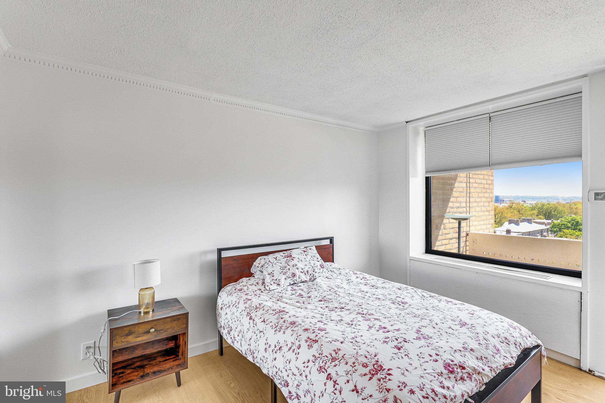 1245 4th Street Southwest, Unit E711 Washington, DC 20024 - Photo 11 of 33 a bedroom with a bed and a window