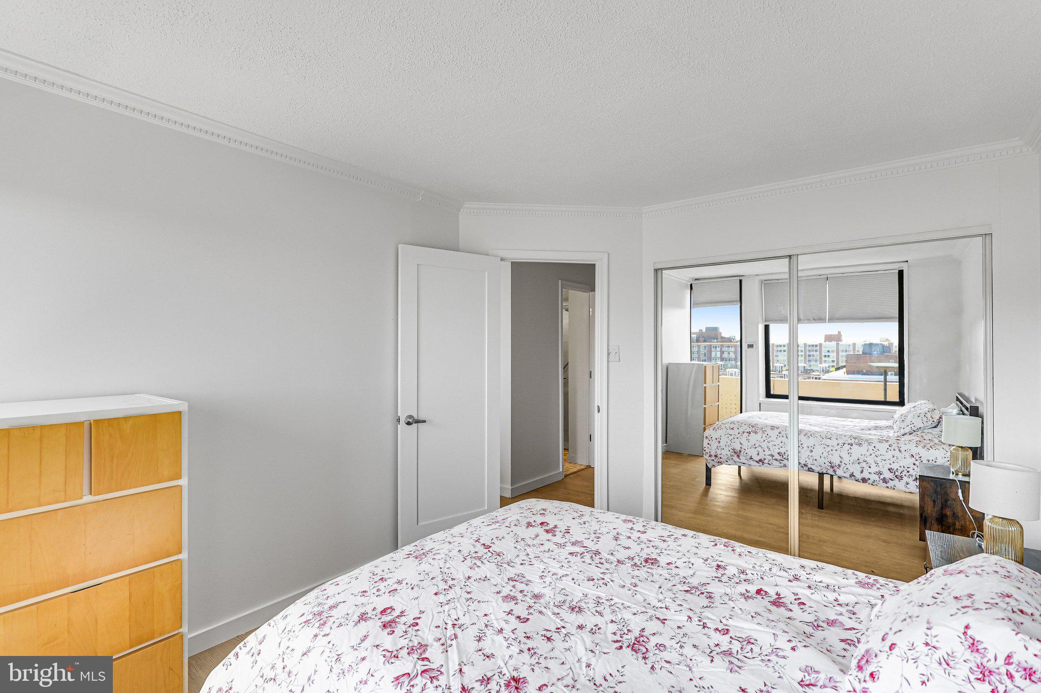 1245 4th Street Southwest, Unit E711 Washington, DC 20024 - Photo 13 of 33 a bedroom with a bed and wooden floor