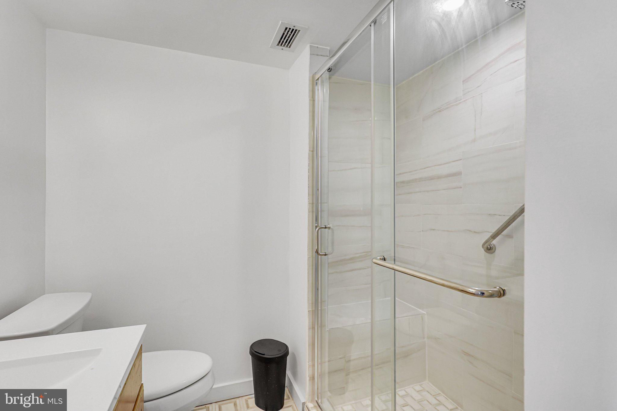 1245 4th Street Southwest, Unit E711 Washington, DC 20024 - Photo 16 of 33 a bathroom with a shower and toilet